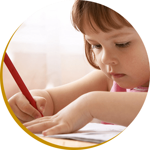 A little girl is writing with a red pencil.